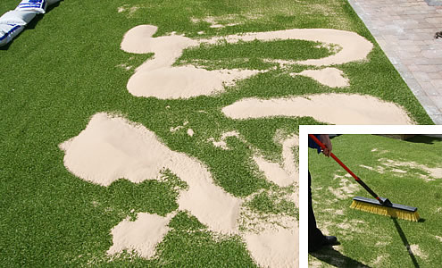 spreading sand on fake grass